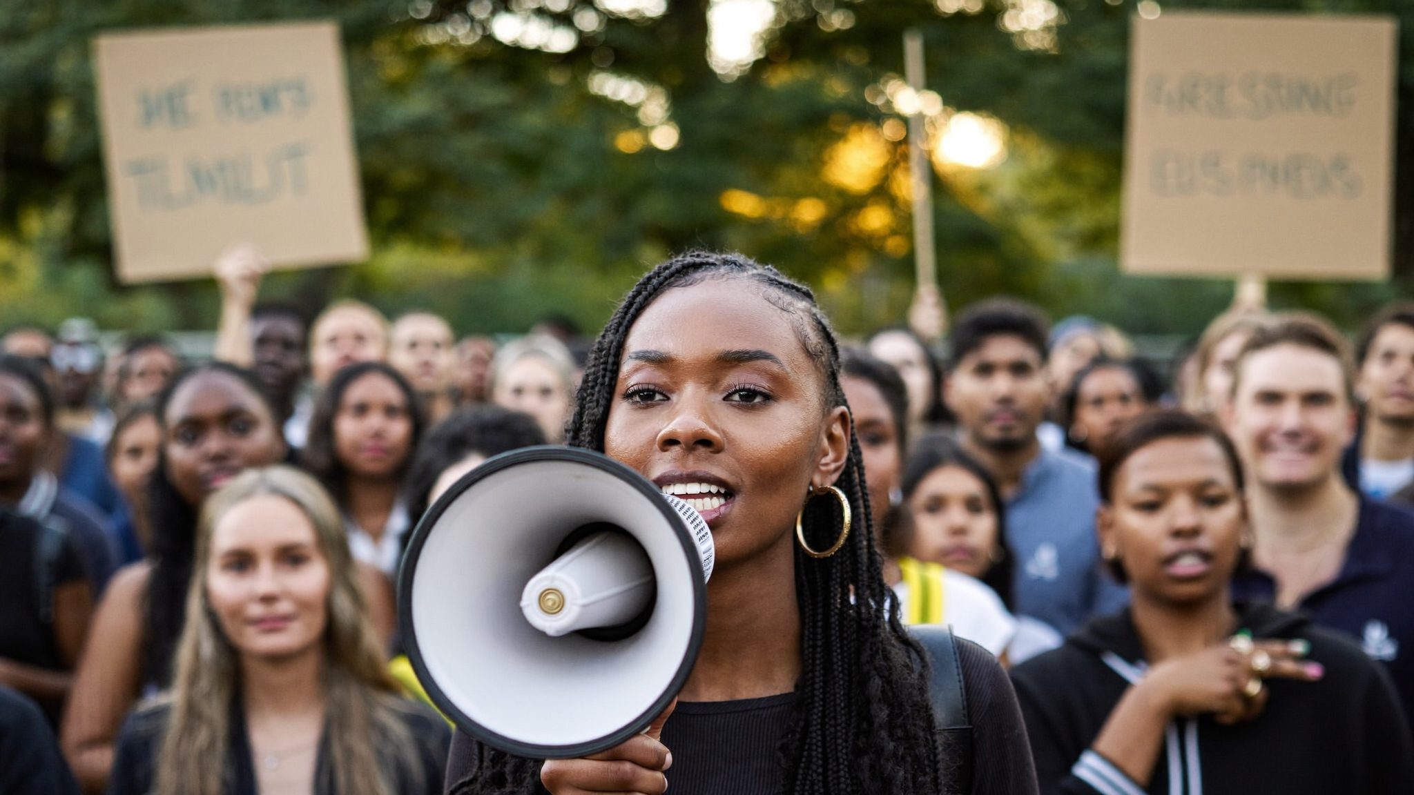 A young woman speaking passionately into a megaphone, representing activism and advocacy.